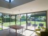 kitchen table surrounded by sliding patio doors in modern home