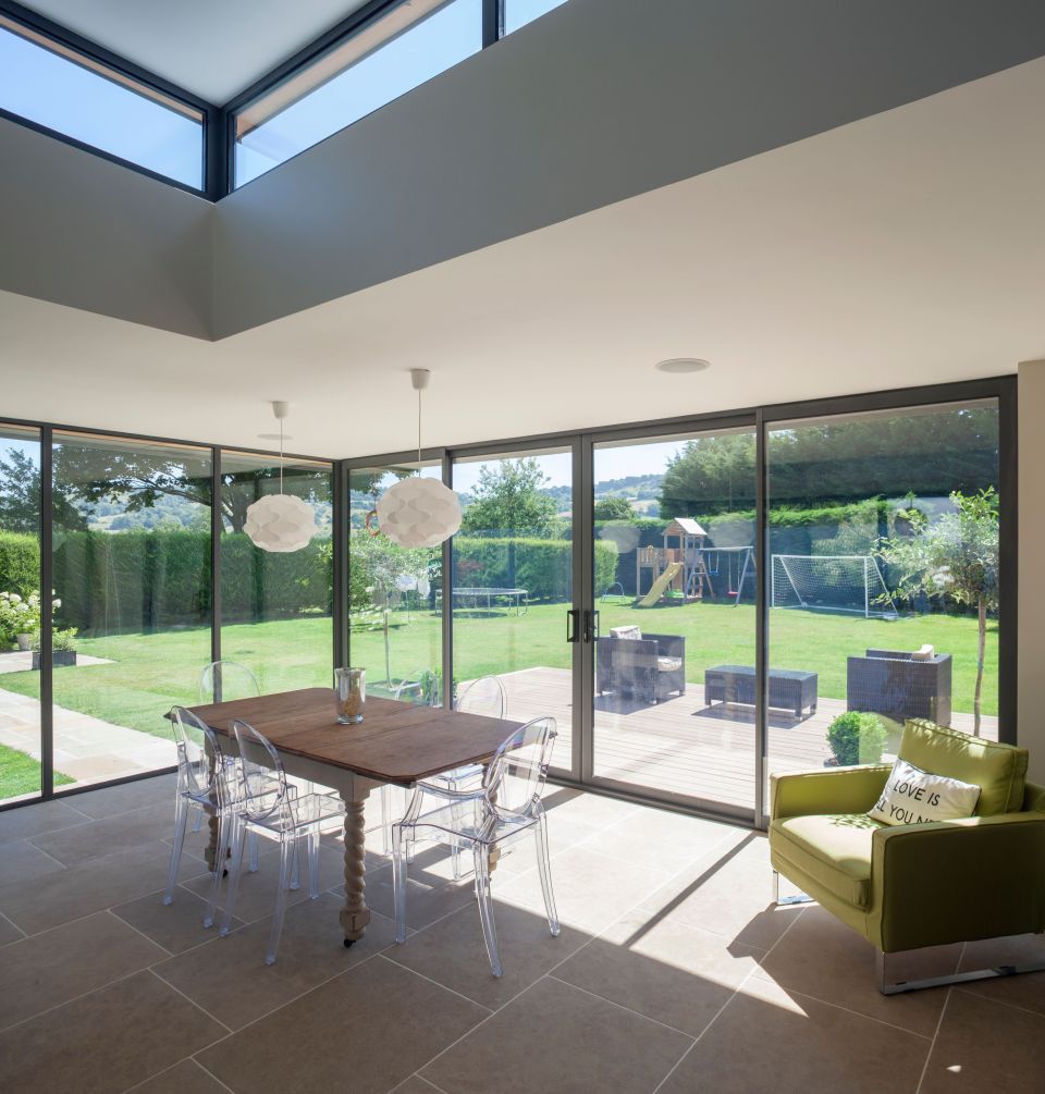 kitchen table surrounded by sliding patio doors in modern home