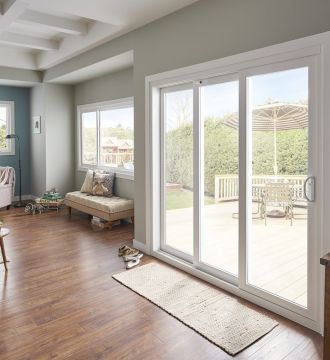 sliding patio doors behind a kitchen table with the ocean in view