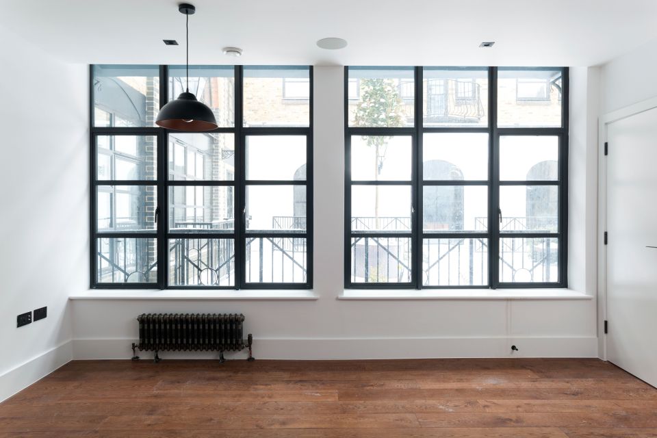 Two large windows in an empty studio like room