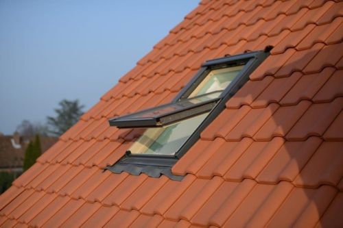 an open skypod window on the tiled roof of a house