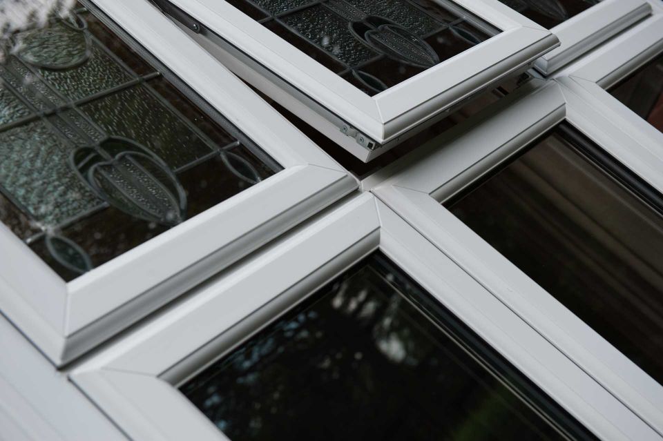 one open and two closed triple glazed windows with designs