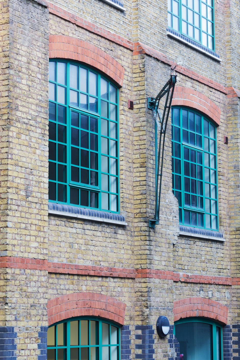 Two large windows on the side of a building