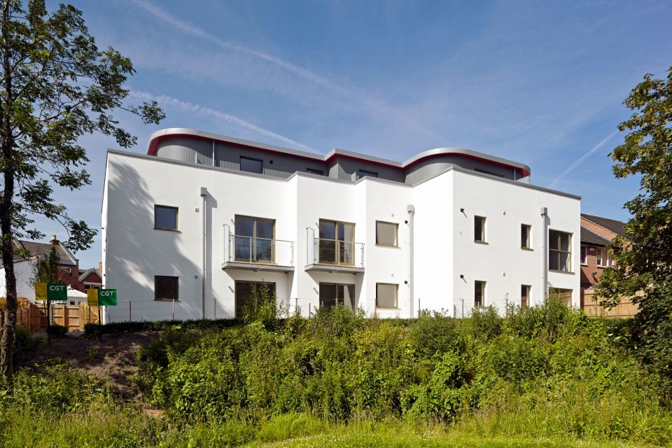 Wide shot of large home with multiple balconies and all windows in view