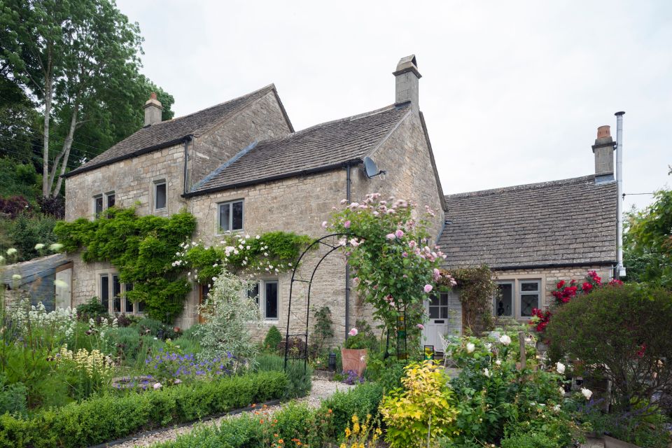 wide shot of a house with windows, door and front garden in view