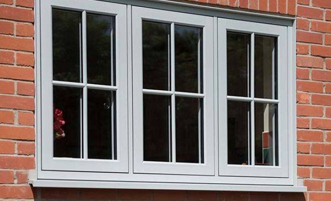 three windows on the front of a house