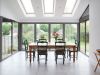 kitchen table surrounded by modern bi-fold doors 