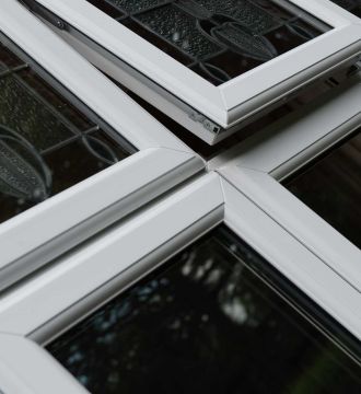 one open and two closed triple glazed windows with designs