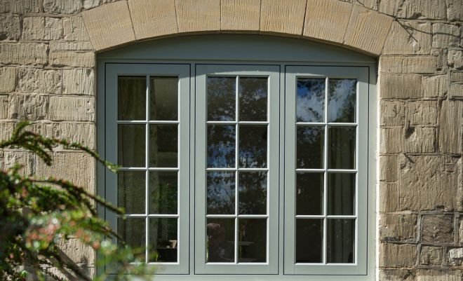 three windows on the front of a house