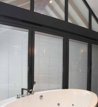 bathroom with large blinded glass windows 