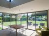 kitchen table surrounded by sliding patio doors in modern home