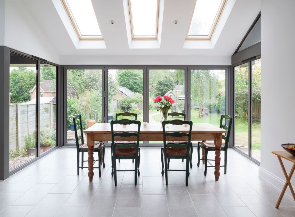 kitchen table surrounded by modern bi-fold doors 